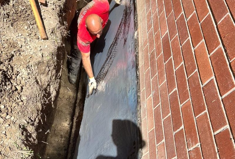 Basement waterproofing work in progress in Etobicoke with excavation around the foundation.